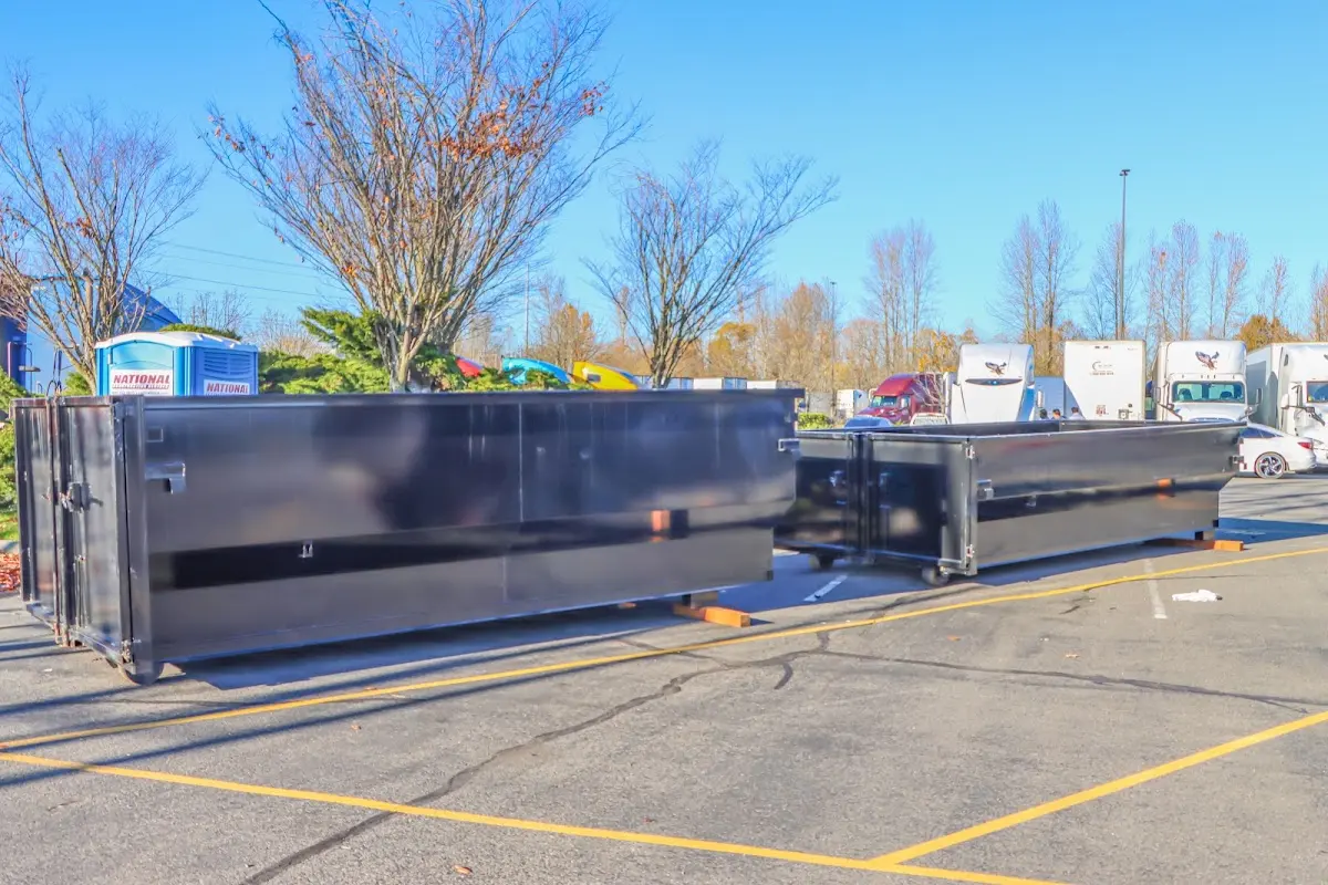 Professional dumpster rental service with roll-off container on residential driveway in Dos Palos